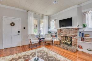 a living room with a fireplace and a tv at Noble Cottage 3 Bed 1 Bath in Augusta