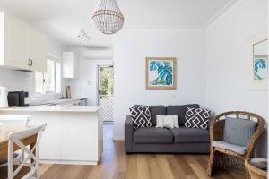 a living room with a couch and a kitchen at Blue Vista in Nelson Bay