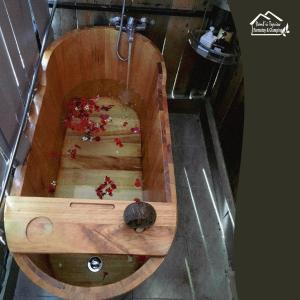a wooden boat with a turtle sitting in it at Đamb'ri Top View Farmstay & Glamping in Bao Loc