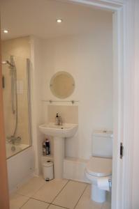 a bathroom with a toilet and a sink and a shower at Watford Gemini Hurst in Watford