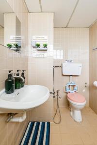 a bathroom with a sink and a toilet at EE's Surfer's House - Seaview, 3 min walk to beach in Batu Ferringhi