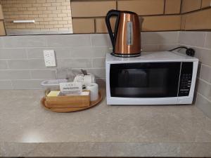 a microwave on a counter with a coffee pot on it at Mount Wycheproof Motor Inn in Wycheproof