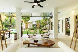 a living room with a ceiling fan and a table at PROMO! Luxury Villa Escape in Ubud 2 BR in Ubud