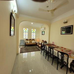 a living room with a table and chairs and a couch at Vazeer Residancy in Hyderabad