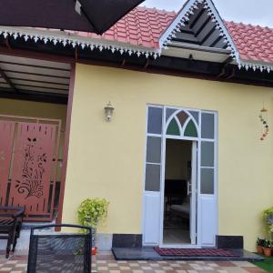 a house with a door and a red roof at Vazeer Residancy in Hyderabad