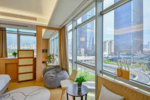 a bedroom with a bed and a large window at Shenzhen Duowei Luxury Apartment Chegongmiao Branch in Shenzhen