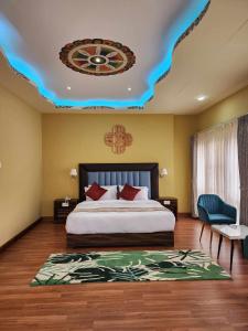a bedroom with a bed and a ceiling with a clock at Green valley boutique in Paro