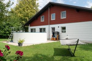 a house with a large white fence in the yard at Ferienwohnung Bichler in Altötting