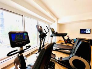 a gym with two exercise bikes and a television at Chatrium Niseko Japan in Niseko