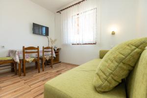 a living room with a couch and a table at Apartment Vesna - 100m from sea in Luka