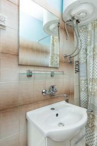 a bathroom with a white sink and a mirror at Apartment Vesna - 100m from sea in Luka