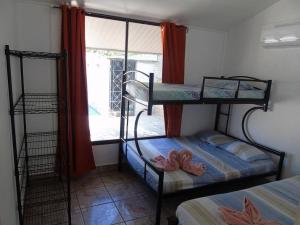 a room with two bunk beds and a window at Conchal Maquito House in Brasilito