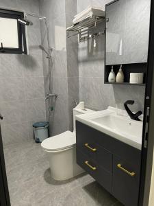 uma casa de banho com um WC, um lavatório e um chuveiro em Snu Motel - Cao Bằng em Cao Bang