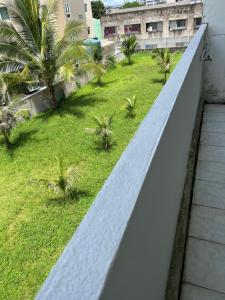 a view from the balcony of a building with palm trees at Piano Private House in Ban Kohong