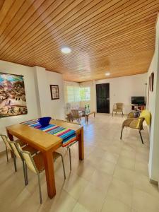 een woonkamer met een houten plafond en een tafel en stoelen bij Excelente apto cerca al mar in Cartagena