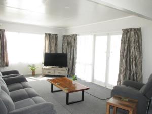 a living room with two couches and a television at The Mitch in Wairoa