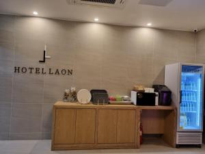 a hotel lobby with a hotel loan sign on a wall at Hotel Laon in Tongyeong