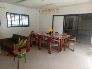 a living room with a table and a couch at Villa sakinu in Mahajanga