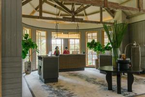 a lobby of a restaurant with a table and a counter at Novus Giri Resort & Spa in Puncak