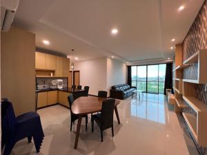 a kitchen and living room with a table and chairs at Nick's Homestay @Boulevard mall @ Imperial Suites in Kuching
