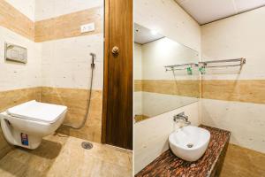 two pictures of a bathroom with a toilet and a shower at FabHotel Aman Sara in Lucknow