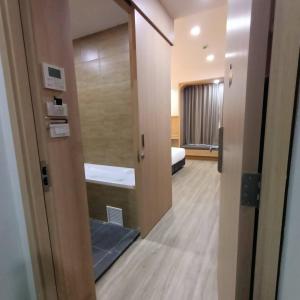 a room with a door leading to a bedroom at Mayflower Grande Suite Hotel in Phitsanulok