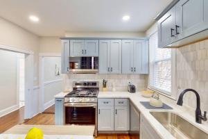 a kitchen with white cabinets and a stove top oven at Forever Boston-5 mil Fenway, FreePrkg in Boston