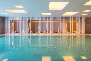 a swimming pool in a hotel room with chairs at Andaz Seoul Gangnam in Seoul