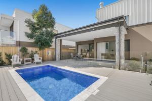 a swimming pool in the backyard of a house at Luxurious Lakeside Oasis in Morisset East
