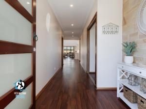 a hallway of a home with wood floors at Luxury Waterfront Holiday Home - Bring the Boat! in Hindmarsh Island