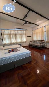una camera con 2 letti in una stanza con pavimenti in legno di home near MRT Tha Phra Villa sookkasem a Bangkok Yai