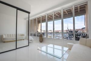 a living room with white furniture and large windows at LUXE SUR LE PORT in Marseille