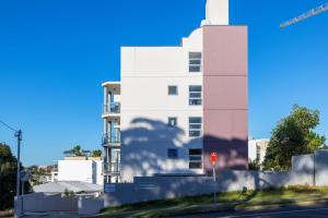 a white building on the side of a street at Nelson Bay Apartment with views over the Marina in Nelson Bay