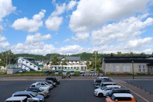 a parking lot with a bunch of cars parked at ヴァンテアン舎（vingt et un house） in Biei