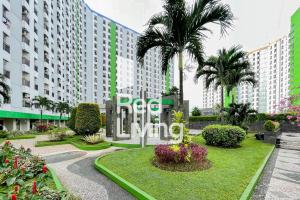 a large building with a sign that reads dream living at RedLiving Apartemen Green Lake View Ciputat - Aurora Rooms in Pondokcabe Hilir