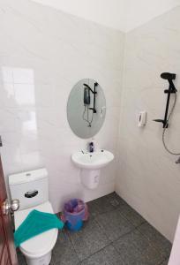 a bathroom with a toilet and a sink and a mirror at ChanthaSouk Vang Vieng Entire Villa in Vang Vieng +23 photos