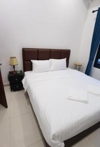 a bedroom with a large bed with white sheets at ChanthaSouk Vang Vieng Entire Villa in Vang Vieng