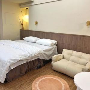 Postel nebo postele na pokoji v ubytování 小隱居Hermit Dorm-聖雄商旅