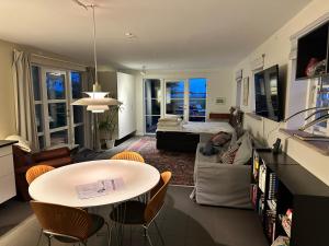 a living room with a table and a couch at Langø Feriecenter - Sea View in Langø