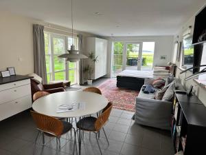 a living room with a table and a couch at Langø Sea View in Langø