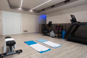 a room with a gym with a treadmill and exercise equipment at Hotel Alla Corte SPA & Wellness Relax in Bassano del Grappa