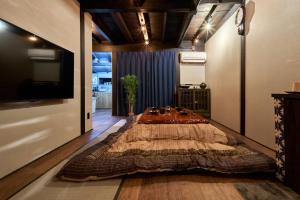 una camera da letto con un grande letto sul pavimento di おやど紀伊国屋 丸山町 庭 a Nagasaki