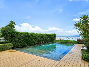 a swimming pool in the middle of a wooden deck at Beacon Executive Suites by NGN in George Town