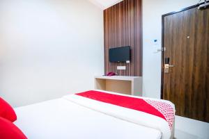 a bedroom with a bed with a red blanket on it at OYO 428 Hope Hotel in Johor Bahru