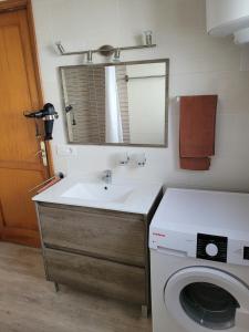 a bathroom with a sink and a washing machine at Lago Verde Suite 25 in Puerto del Carmen