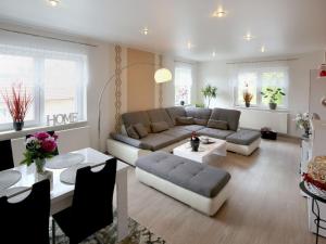 a living room with a couch and a table at Ferienwohnungen Haus Angela in Mühlhausen
