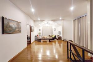 a living room with a couch and a table at Bann White Chalet Khaoyai in Mu Si