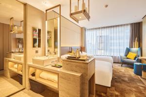 a hotel room with a bed and a bathroom at ECHARM Plus Hotel - Hangzhou Binjiang Starlight Avenue in Hangzhou