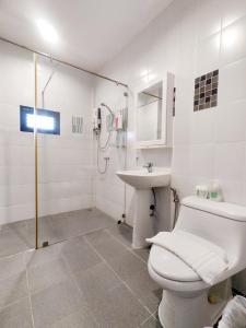 a white bathroom with a toilet and a sink at Bann White Chalet Khaoyai in Mu Si