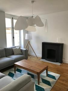 a living room with a couch and a coffee table at Appartement de charme in Saint Malo